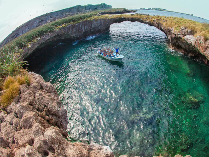 Aerial view of the hidden beach crater at the Marietas Islands with a small boat inside