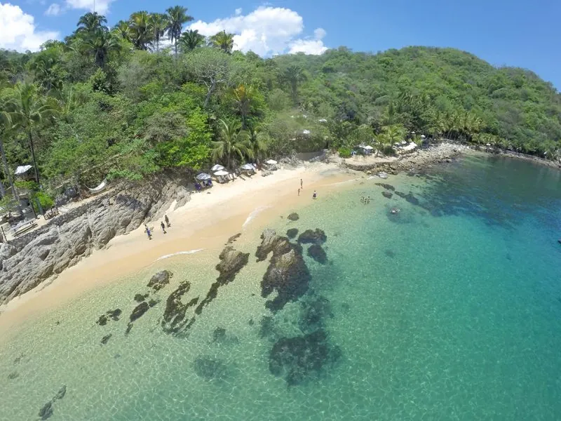 Aerial view of the turquoise cove and white beach of Las Caletas