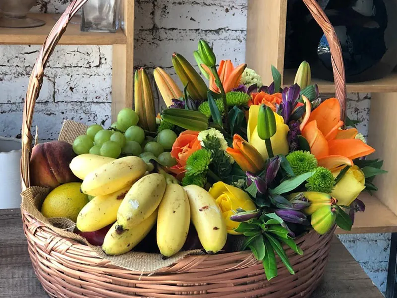 Basket of tropical fruit and flowers