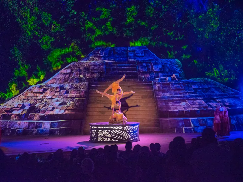 Dancer on the illuminated pyramid stage at Rhythms of the Night