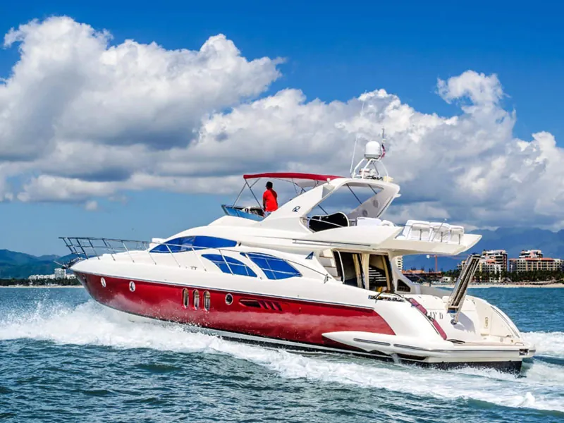 Motor yacht cruising at speed across the bay