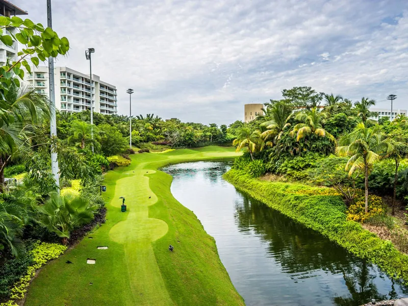 Tree-lined fairway beside a lagoon at a Puerto Vallarta golf course